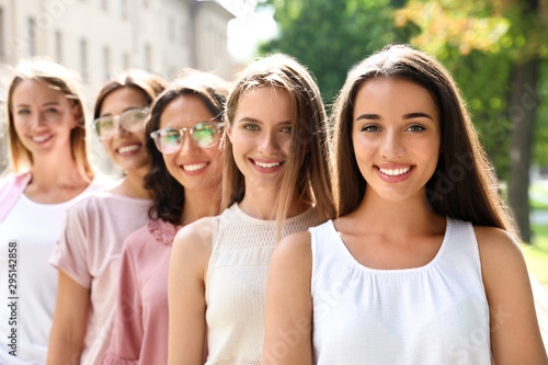 Happy women posing outdoors on sunny day. Girl power concept