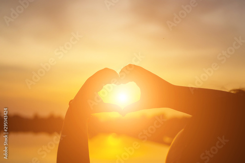 Hand of Young Woman Enjoying Nature with sunrise.