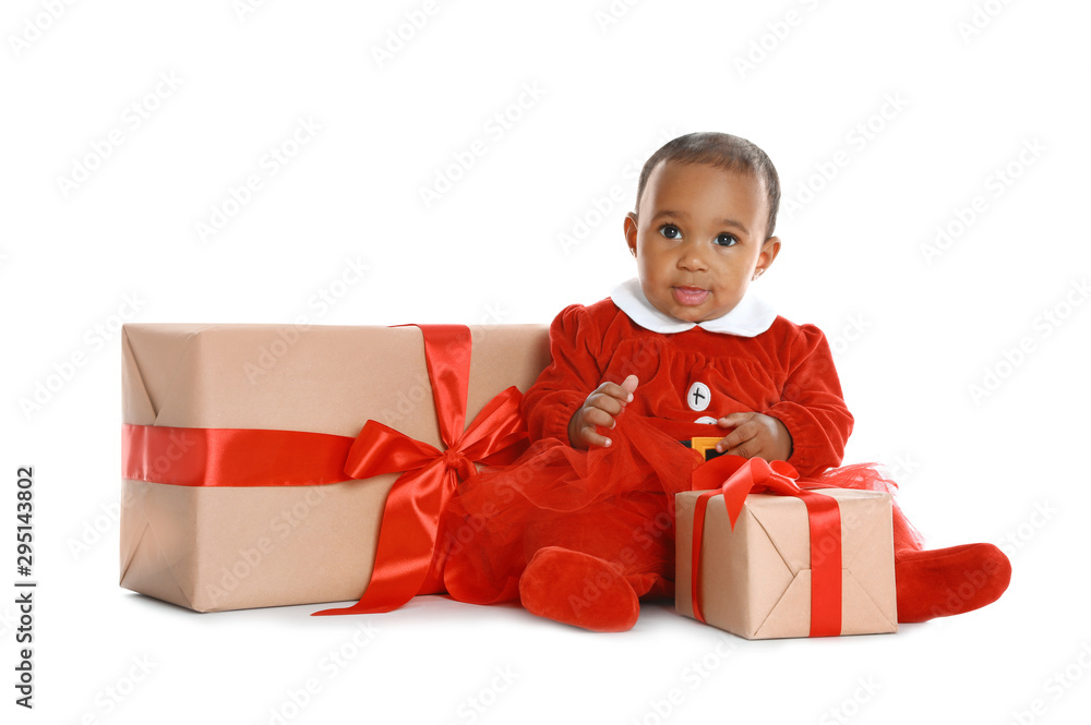 Little African-American baby with Christmas gifts on white background Little African-American baby with Christmas gifts on white background
