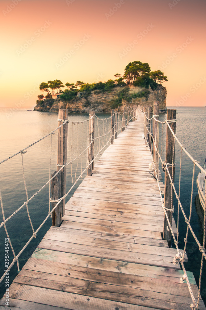 The sunrise at Agios Sostis Island, Cameo Island in Zakynthos, Greece. Wooden bridge.