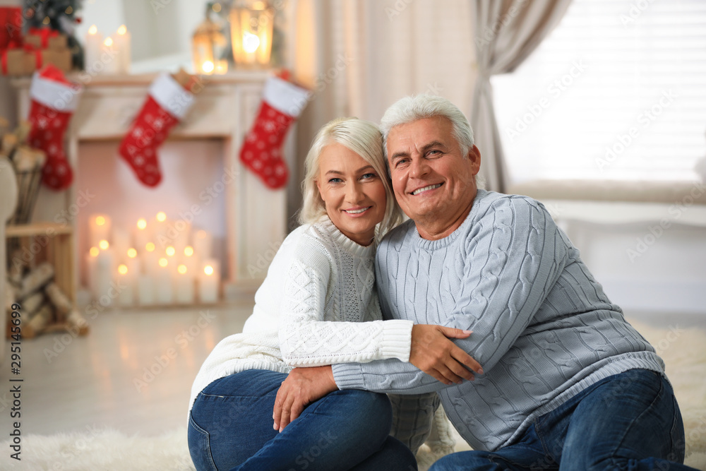 Happy mature couple at home. Christmas celebration Happy mature couple at home. Christmas celebration