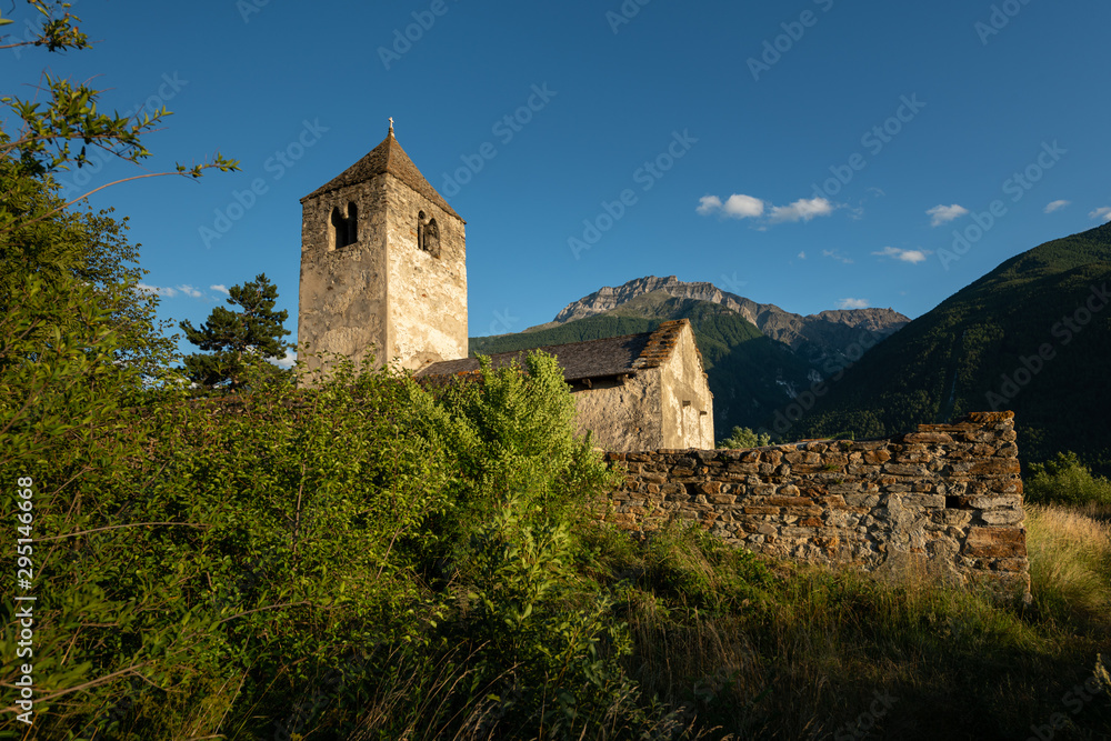 Old chapel St. Sisinius in Laas on a sunny evening in summer Old chapel St. Sisinius in Laas on a sunny evening in summer