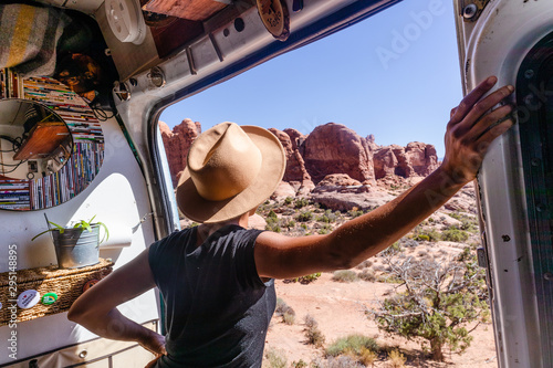 Woman looking out the window of a camper van