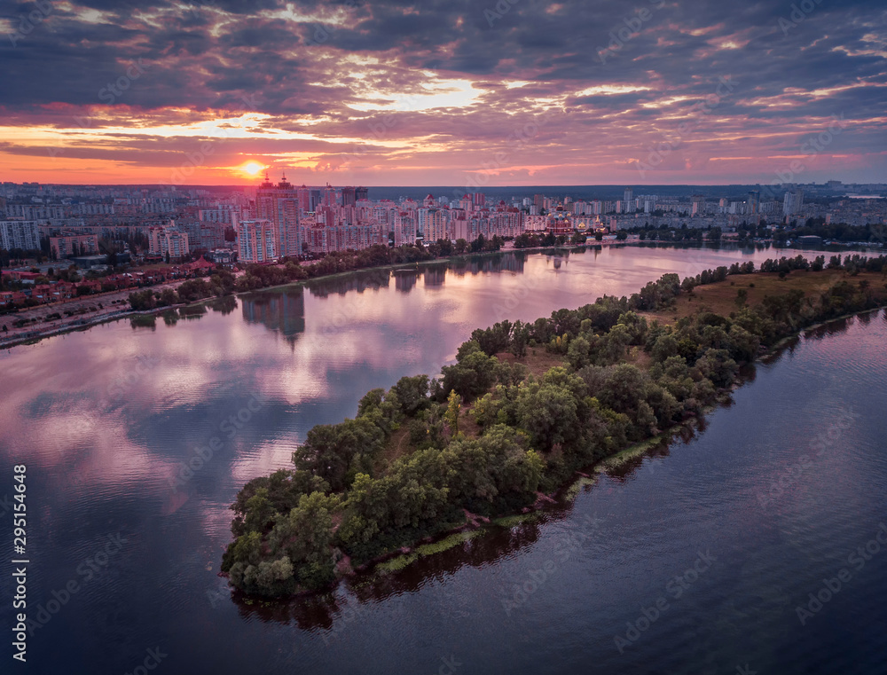 Beautiful aerial view of Obolonska quay in Kyiv, Ukraine; colorful reflection on the water of Dnieper