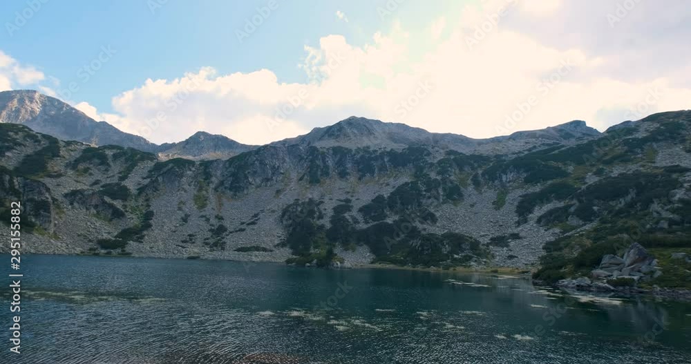 Beautiful landscape with clear lake and mountains in sunny day Beautiful landscape with clear lake and mountains in sunny day