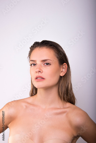 portrait of fashion model beautiful girl with freckles in studio, close up, beautiful girl young woman