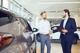 Auto business. The buyer and seller of cars make a handshake