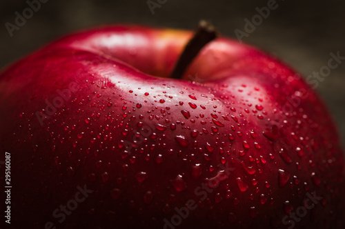Apple red. Close-up of an apple. Water spray droplets.
