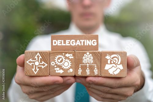 Delegating Leadership Business Organization Concept. Leader arranging wooden blocks with delegate concept. photo