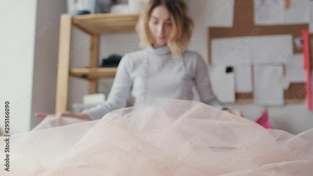 Clothing designer working at a studio table in a garment factory
