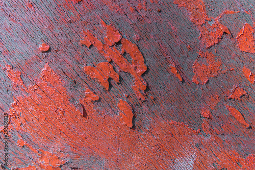 weathered cracked red color paint on rustic wooden crooked panel
