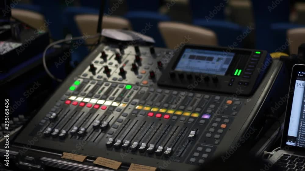 The DJ is adjusting the volume of the sound. Professional audio mixing console.Sound engineer work. The DJ is adjusting the volume of the sound. Professional audio mixing console.Sound engineer work.