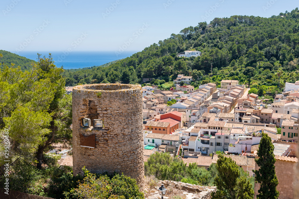 Old tower with historic city of Capdepera seen from Capdepera Castle located in the east of Majorca, Spain