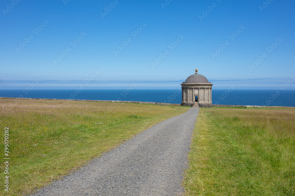 Mussenden Temple against blue sky and Atlantic  ocean on the North-Western coastline of Northern Ireland