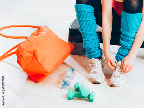 Active lifestye. Woman legs in sneakers, preparing for working out at gym. photo