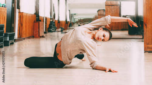 Choreography gymnastics. Woman performing sensual move in dance hall.