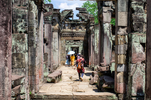 Siem Reap / Cambodia - May 27 / 2019 : tourists walking between the arches of the preah khan temple at angkor wat temple complex © Tayfun