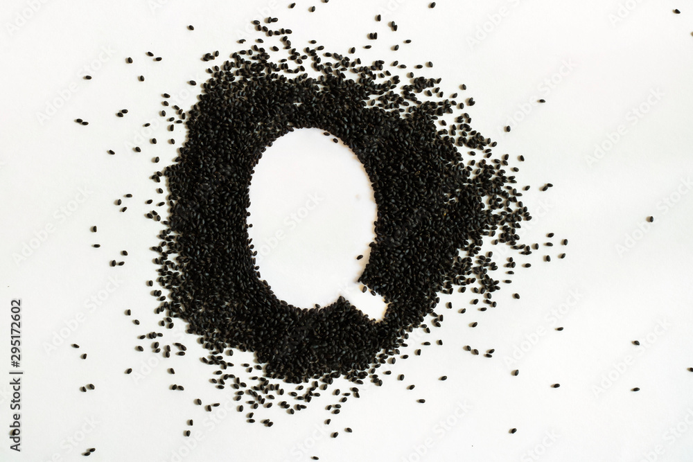 Handful of sweet basil black seeds, letter Q uppercase of English alphabet on white background. Black and white. Lettering. Typography. Healthy and super food. Horizontal Handful of sweet basil black seeds, letter Q uppercase of English alphabet on white background. Black and white. Lettering. Typography. Healthy and super food. Horizontal