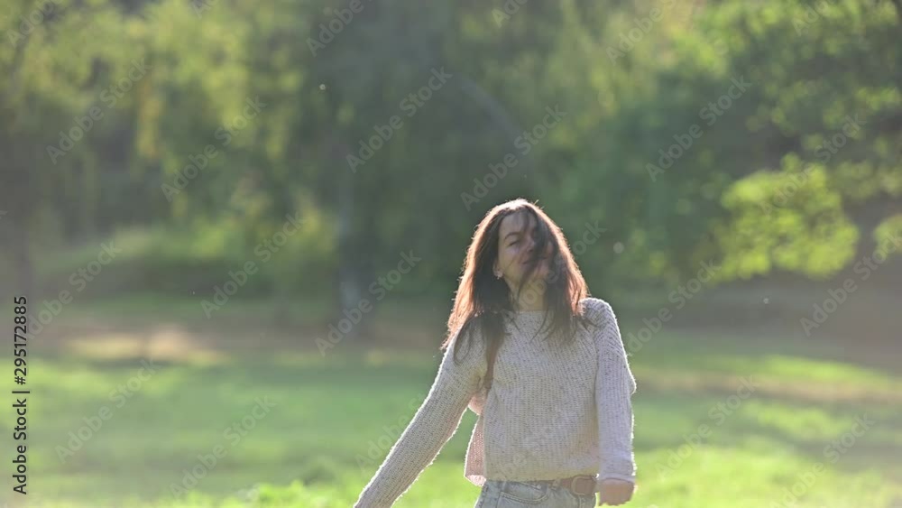 Young attractive brunette woman spinning around enjoying summer day in the park Young attractive brunette woman spinning around enjoying summer day in the park