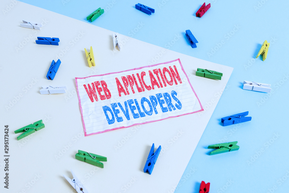 Conceptual hand writing showing Web Application Developers. Concept meaning Internet programming experts Technology software Colored clothespin paper reminder with yellow blue background