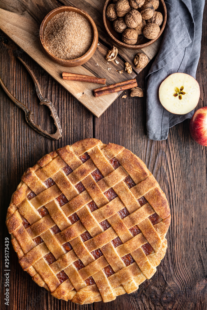 Homemade dessert, old fashioned lattice crust pie with grated apple and walnut filling, sprinkled with granulated sugar and cinnamon Homemade dessert, old fashioned lattice crust pie with grated apple and walnut filling, sprinkled with granulated sugar and cinnamon