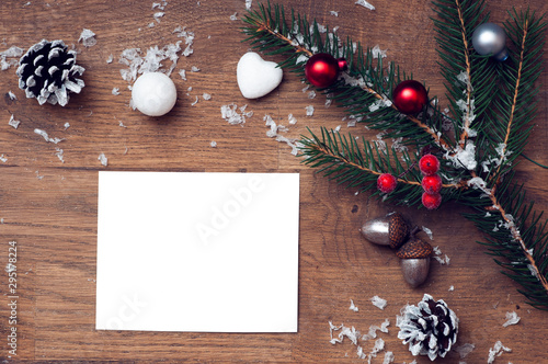 christmas card with stars,fir and fir-cone on wooden background