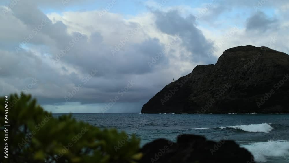 A steady shot sped up recording of a scenic island mountain showing the sea and the horizon in the backdrop of a very cloudy sky. A steady shot sped up recording of a scenic island mountain showing the sea and the horizon in the backdrop of a very cloudy sky.