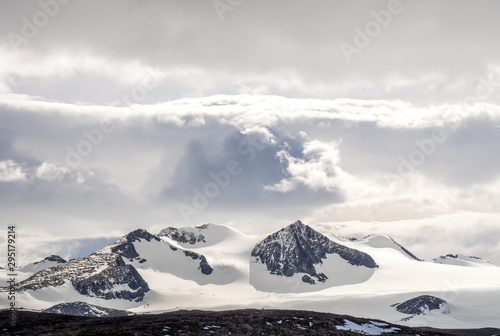 Snow covered mountains in Antarctica under cloudy sky © Katherine Rock