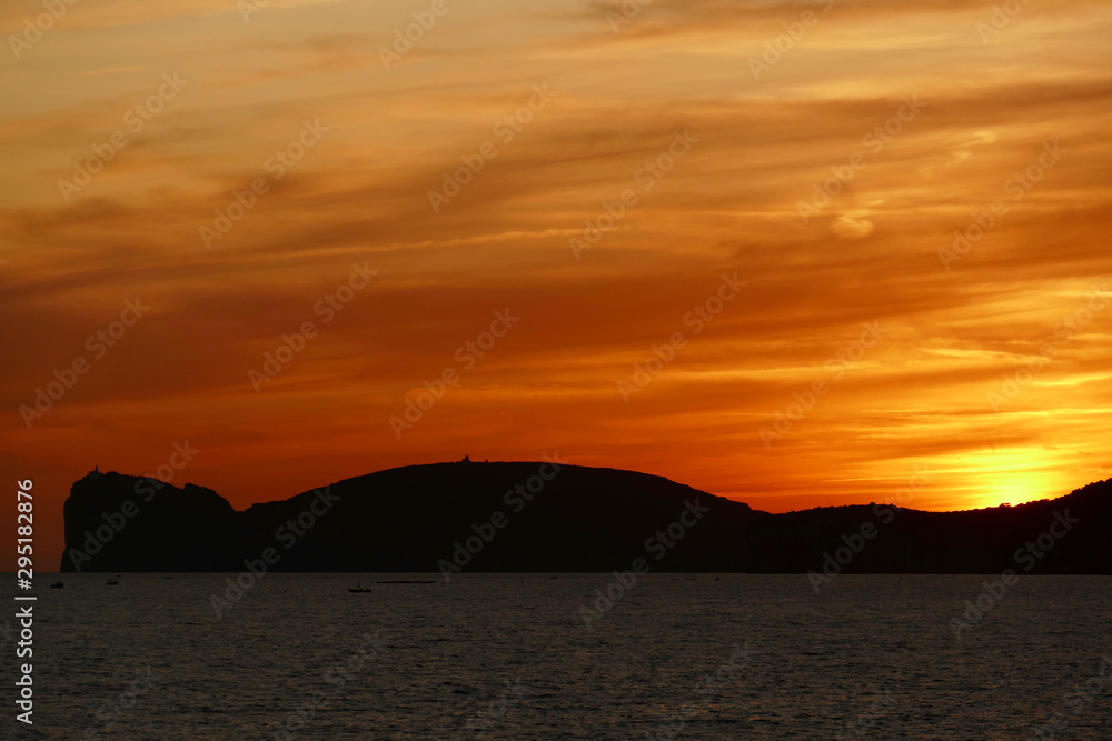 Sunset in Alghero, Sardinia, Italy. Capo Cassia in the background. Sunset in Alghero, Sardinia, Italy. Capo Cassia in the background.