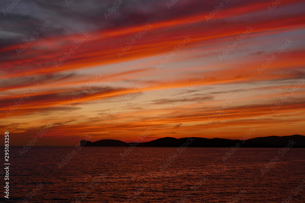 Sunset in Alghero, Sardinia, Italy. Capo Cassia in the background.