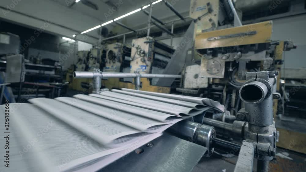 Paper with printed text is getting transported by the conveyor Paper with printed text is getting transported by the conveyor