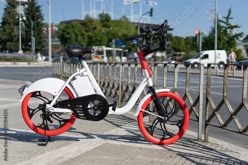 City bicycle Thessaloniki parked electric bike on the sidewalk ready for rent rental bikes services sharing service