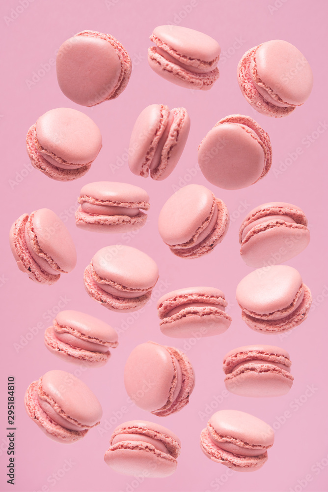 Fototapeta premium Pattern of sweets made of pink macaroons, sweets on a pink background. Pattern of pink macaroons.