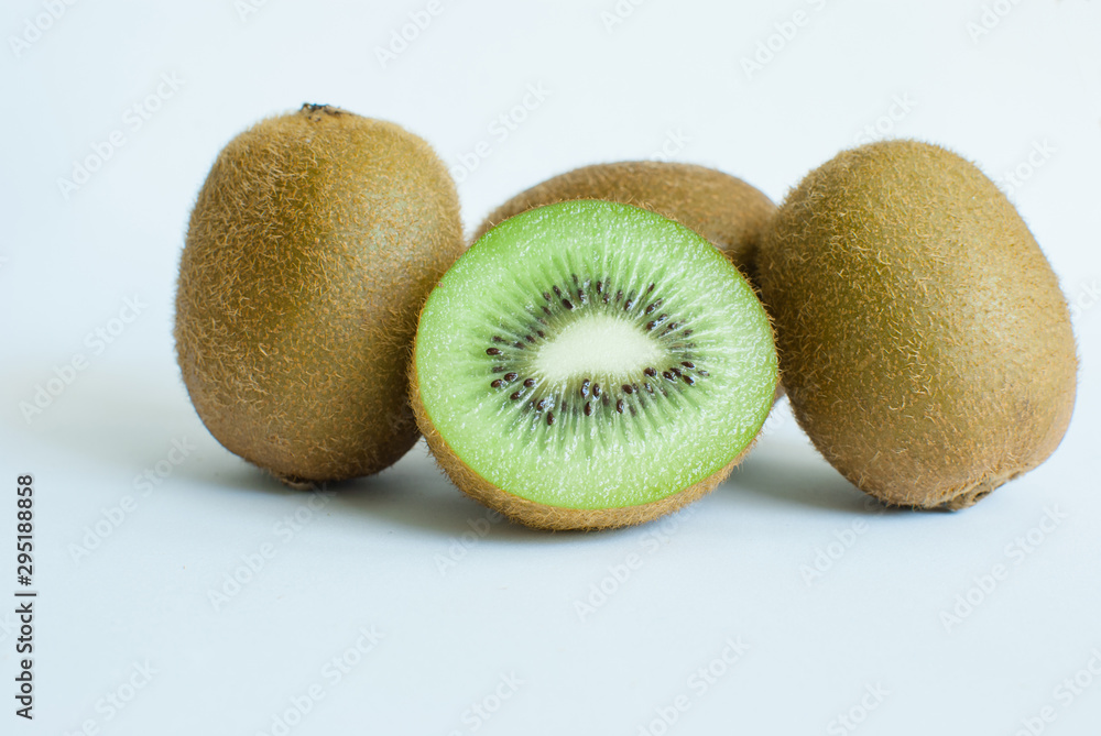 Several cut and whole fresh kiwis on white background Several cut and whole fresh kiwis on white background