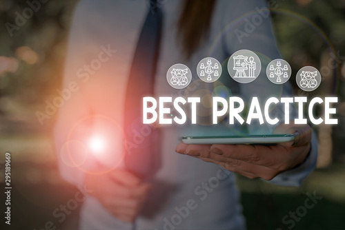 Conceptual hand writing showing Best Practice. Concept meaning Method Systematic Touchstone Guidelines Framework Ethic Woman wear work suit presenting presentation smart device photo