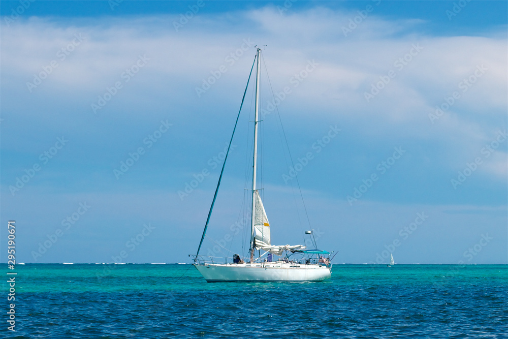 Sailboat at anchor in turquoise and blue water at San Pedro Belize Sailboat at anchor in turquoise and blue water at San Pedro Belize