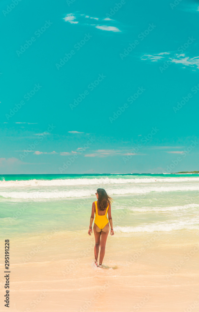 Woman walking on Galapagos beach. Tourist walking along Tropical beach with turquoise ocean waves and white sand. Sand bay view. Holiday, vacation, paradise, summer vibes. Isabela, San Cristobal Woman walking on Galapagos beach. Tourist walking along Tropical beach with turquoise ocean waves and white sand. Sand bay view. Holiday, vacation, paradise, summer vibes. Isabela, San Cristobal