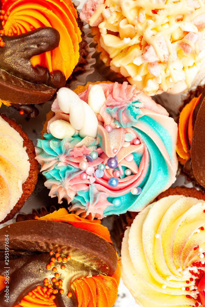Unicorn cupcake surrounded by other colorful cakes