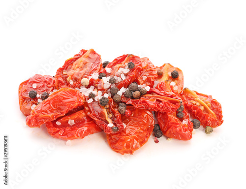 Dried tomatoes and spices on white background