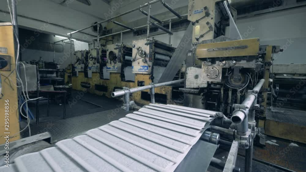 Printed sheets of paper are moving along the industrial transporter Printed sheets of paper are moving along the industrial transporter