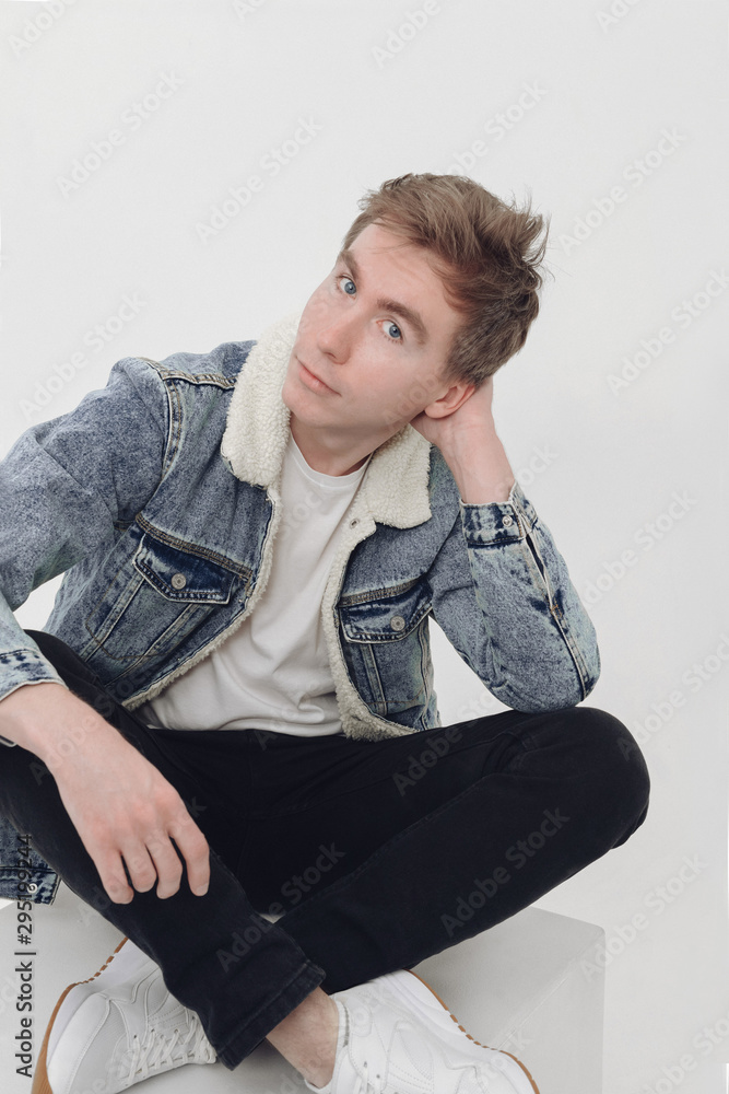 portrait of a handsome young man in a denim jacket portrait of a handsome young man in a denim jacket
