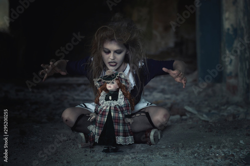 scary girl with a doll in an abandoned house.tinting and noise