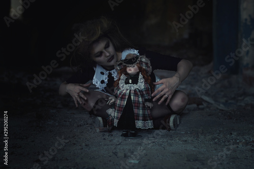 scary girl with a doll in an abandoned house.tinting and noise © евгений ставников
