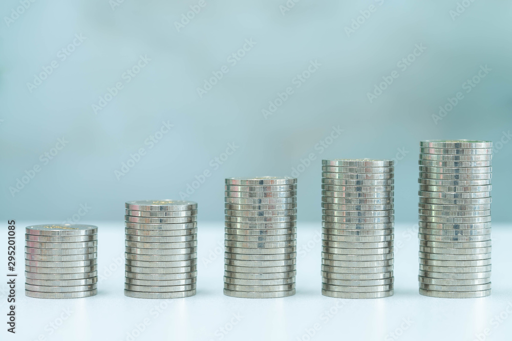 Five stack of coins on vintage background. Savings concept.