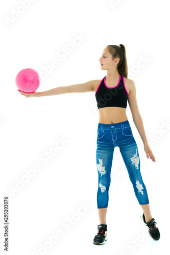 Girl gymnast performs exercises with the ball.