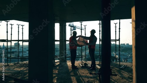 Engineers in uniform work with a bluprint. photo