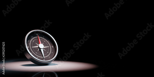 Compass Spotlighted on Black Background photo