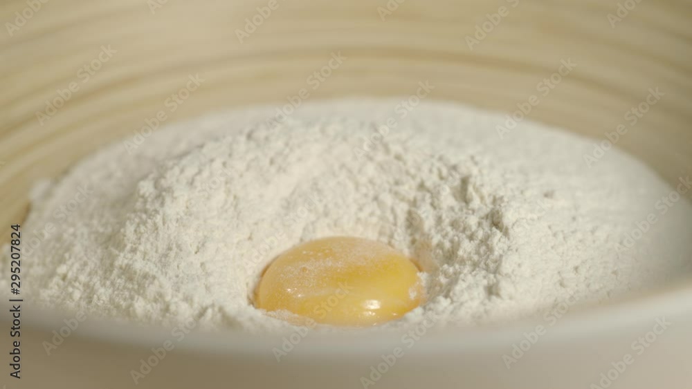 SLOW MOTION: Fresh Chicken Egg Falling Into A Pile Of Flour SLOW MOTION: Fresh Chicken Egg Falling Into A Pile Of Flour