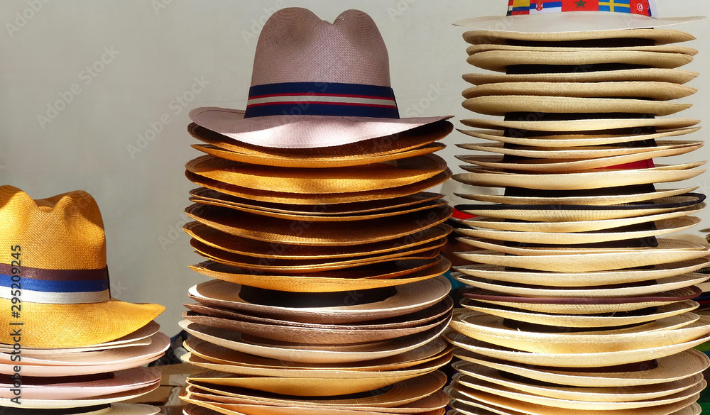 Big group of authentic panama hats or paja toquilla hats, weaving from straw, at craft market in Cuenca, Ecuador