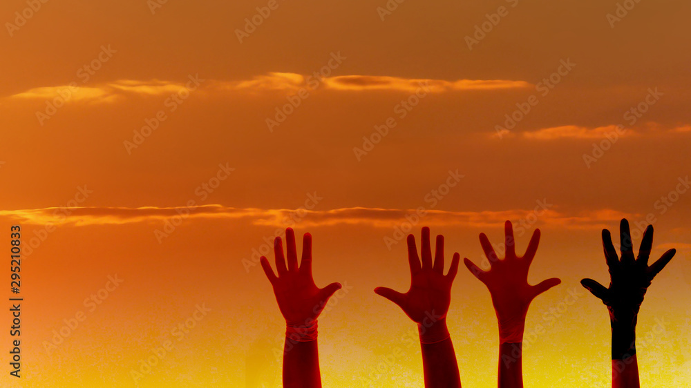  silhouette hands on the beautiful sunset sky . help and team ,teamwork concept.